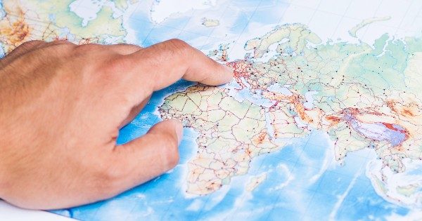 Man pointing a European country on the map